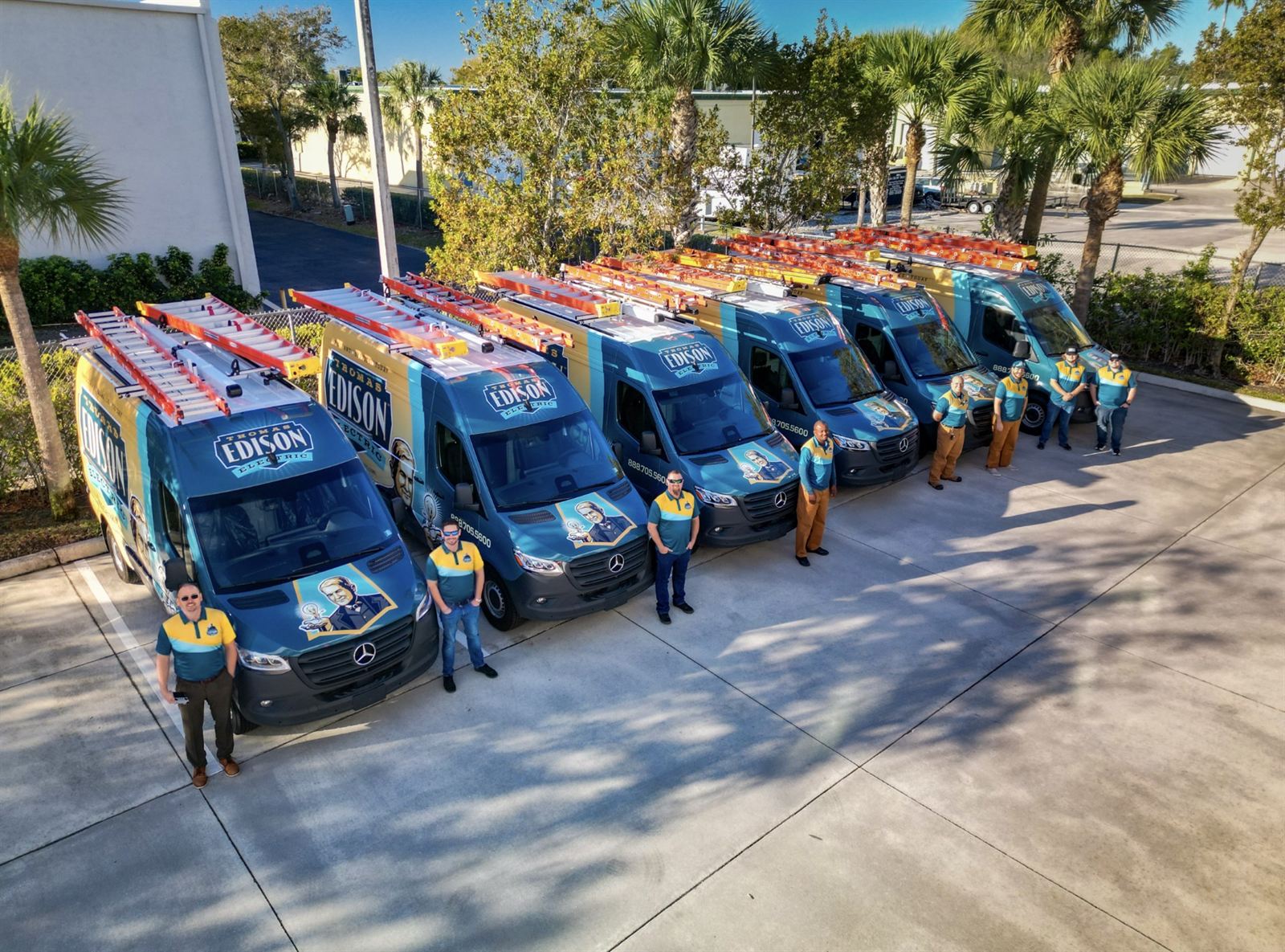 Thomas Edison Electric Sarasota service fleet â€” branded company vans dispatched daily across the metro.